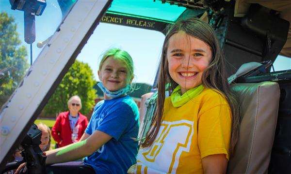 Students sit in helicopter seats